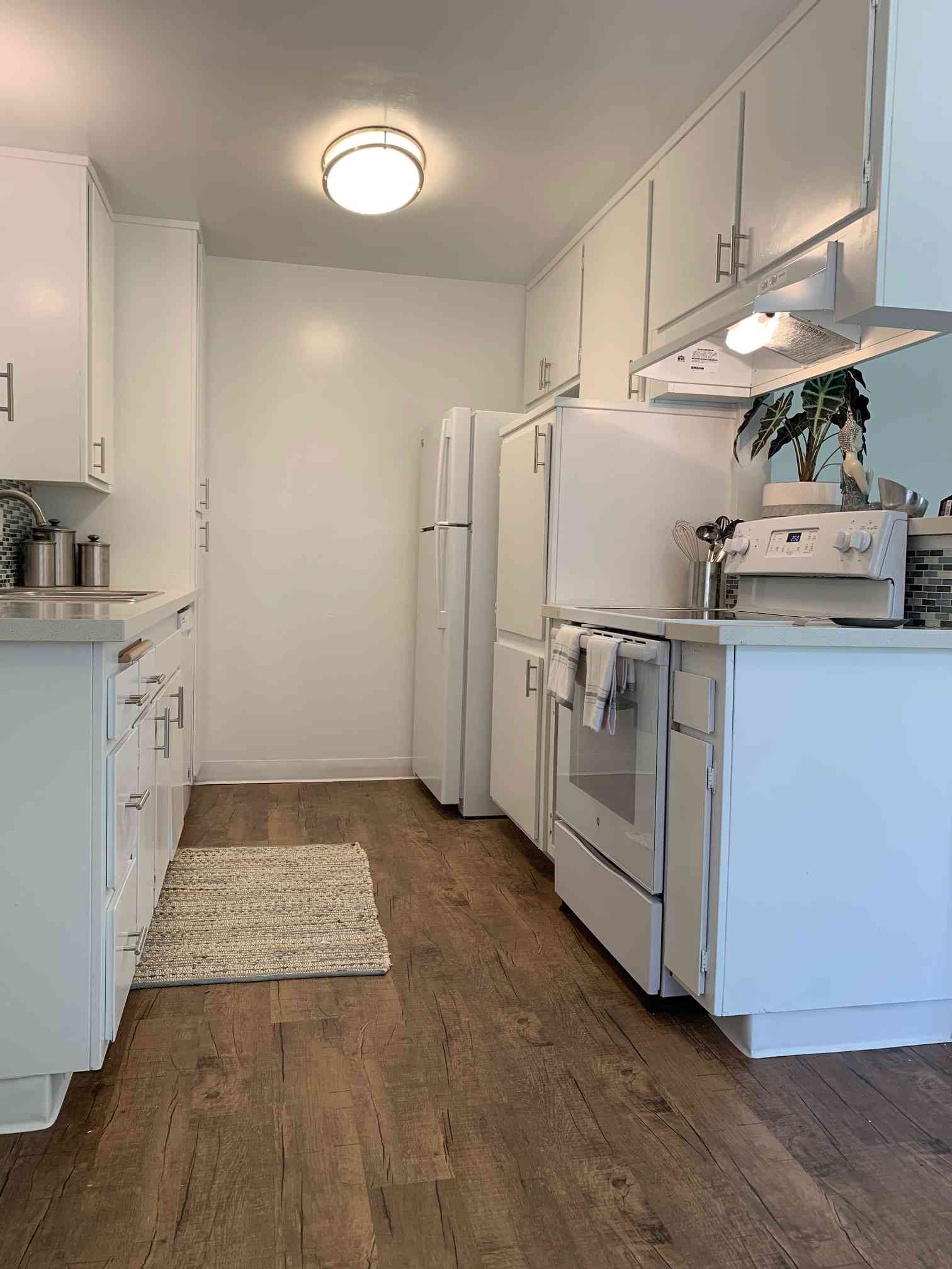 galley kitchen with wood style flooring