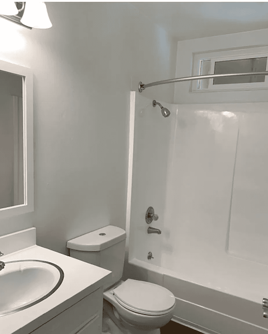 clean bathroom with full sized tub and shower